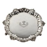 A small George II sliver salver, circular form with cast foliate rim and engraved crest with hay