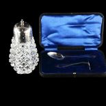 A silver-mounted glass sugar shaker and a cased silver child's christening set (2) No damage or