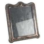 A large Elizabeth II silver-fronted strut photo frame, relief embossed fluted decoration, by Paul