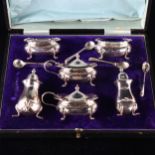 A George V silver 6-piece cruet set, with blue glass liners, by Walker & Hall, hallmarks