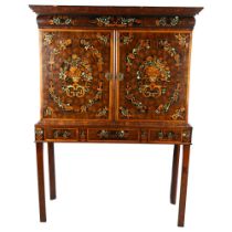 An exceptional William and Mary oyster laburnum and marquetry inlaid cabinet on stand, covered in