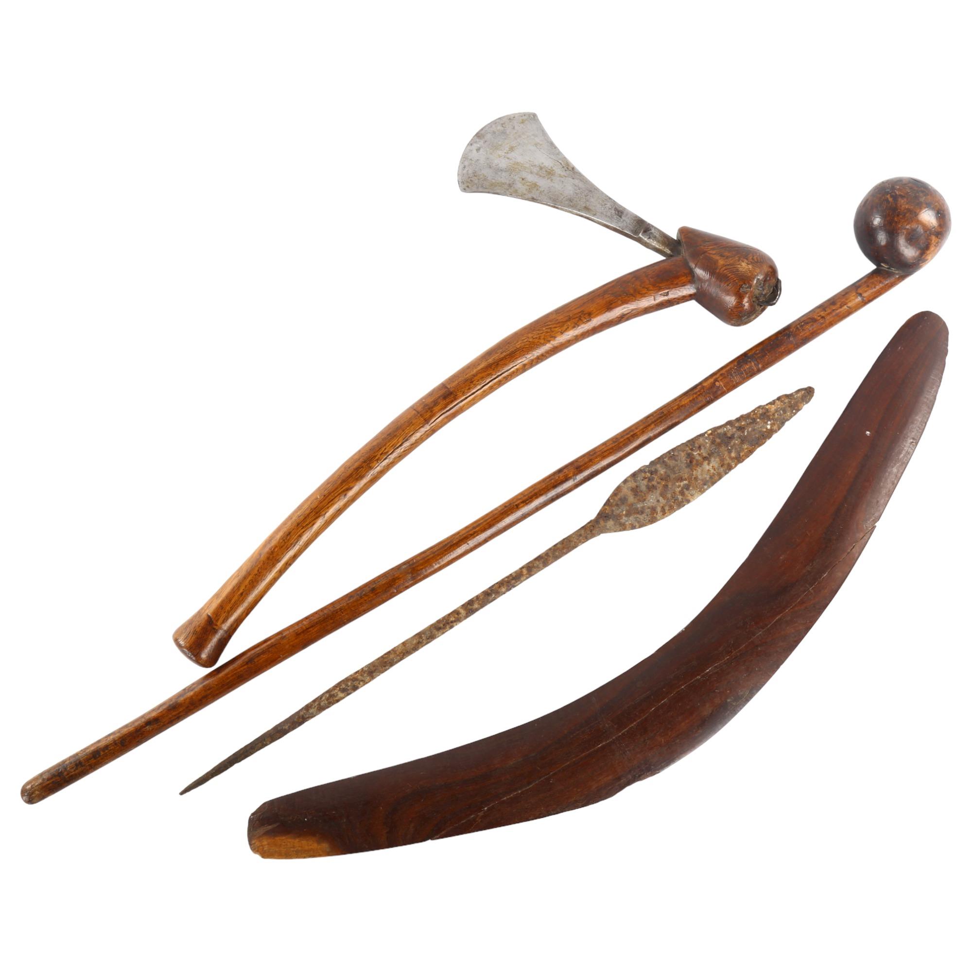 A group of Tribal implements, comprising an Australian boomerang, a rootwood club/knobkerry (