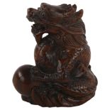 A Chinese carved wood dragon and pearl design netsuke, height 4.5cm