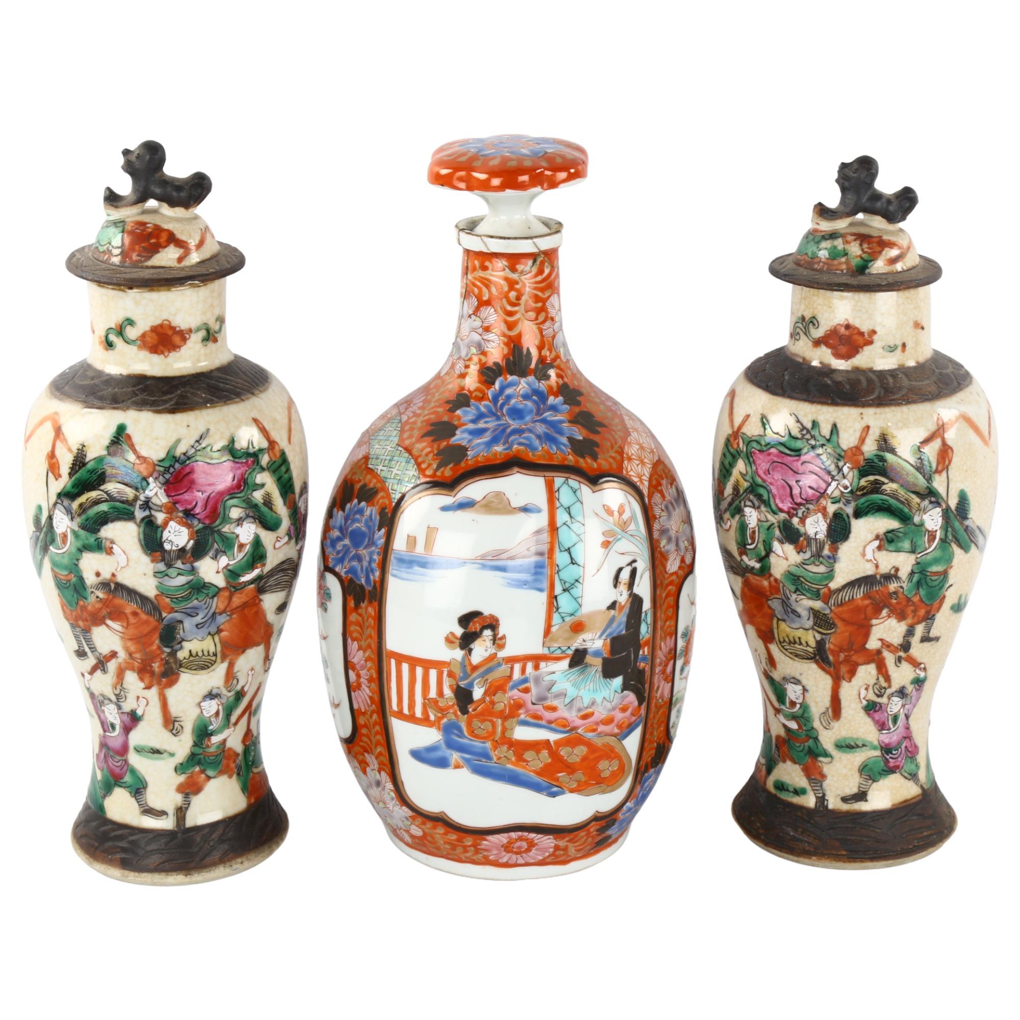 A Japanese porcelain bottle and stopper, with hand painted decoration, 6 character mark, height