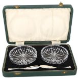 A pair of glass butter dishes, with silver butter knives, hallmarks Sheffield 1937, dish diameter
