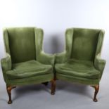 A pair of 19th century upholstered wing armchairs in Queen Anne style, on walnut cabriole legs