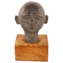 An unusual mid-20th century solid lead head sculpture, on woodblock plinth, unsigned, height 22cm