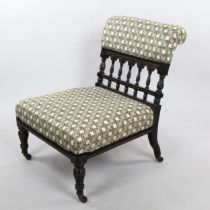 A Victorian Aesthetic Movement nursing chair, ebonised spindled frame recently re-upholstered in