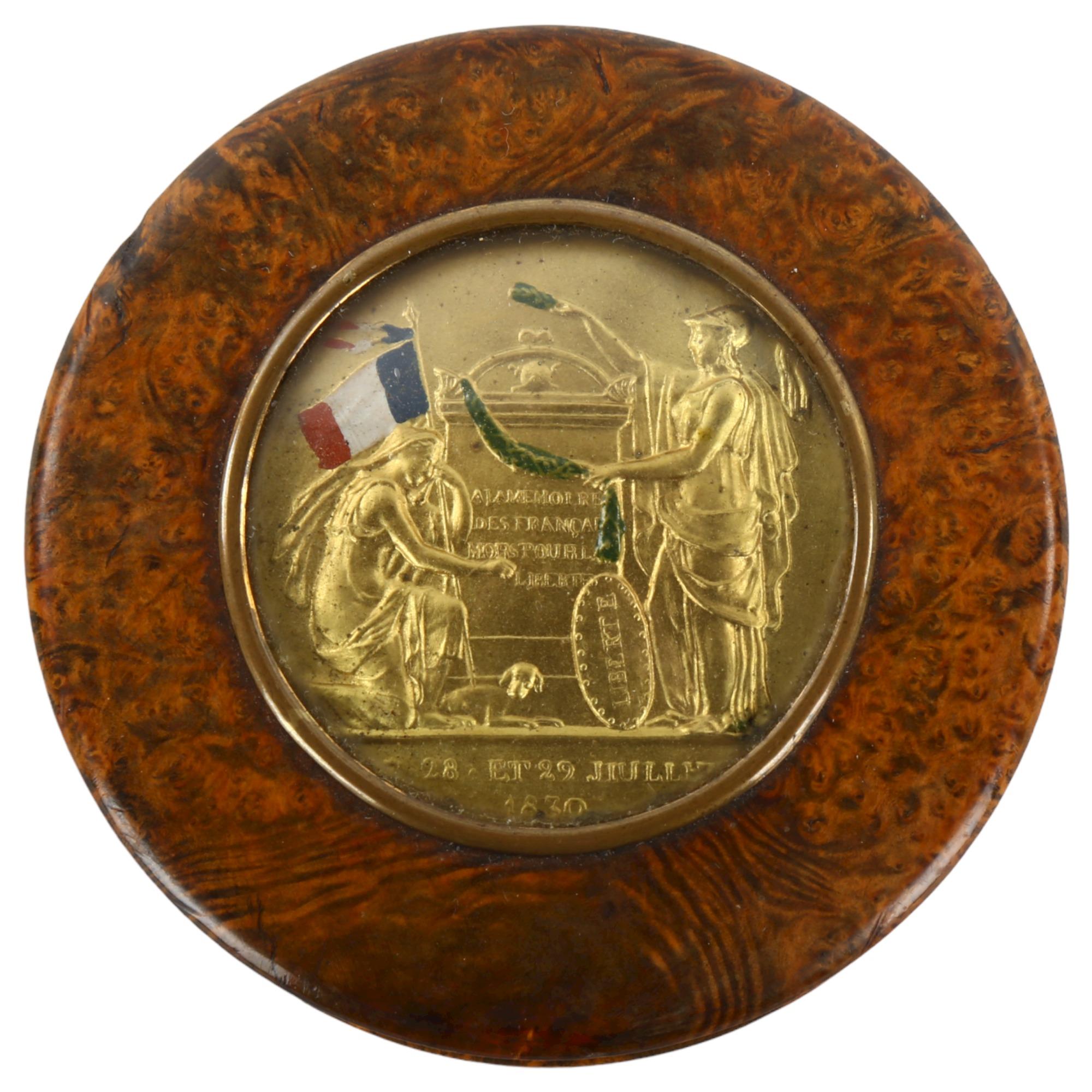 A 19th century French circular burr-walnut box, the lid having an inset medallion commemorating