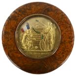 A 19th century French circular burr-walnut box, the lid having an inset medallion commemorating