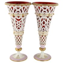 Pair of Bohemian gilded and pierced milk glass vases, with cranberry liners, height 39cm (1 A/F) 1