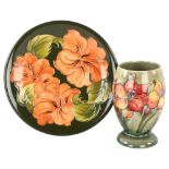 MOORCROFT - African Lily design vase, height 17cm, and a Hibiscus pattern plate, diameter 26cm (2)