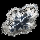 A late Victorian silver quatrefoil bread basket, relief embossed and pierced foliate decoration,