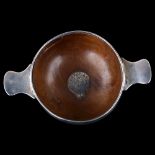 A Scottish turned beech quaich, unmarked silver mounts with central garter motif and thistle emblem,
