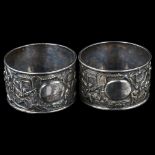 A pair of Chinese export silver napkin rings, circa 1900, relief embossed ceremonial decoration,
