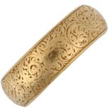 A 19th century 18ct gold wedding band ring, allover engraved foliate decoration, maker's marks WW,