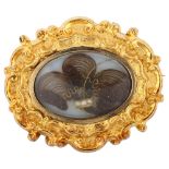A Victorian pinchbeck mourning brooch, unmarked closed back setting with chased foliate design and