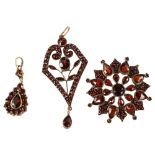 A group of Bohemian garnet jewellery, comprising Art Nouveau pendant, brooch and later pendant,