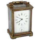 A French brass-cased alarm carriage clock, white enamel dial with Roman numeral hour markers,