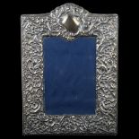 An Elizabeth II silver-fronted photo frame, relief embossed foliate decoration, by Carr's, hallmarks