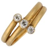 An early 20th century 18ct gold three stone diamond crossover band ring, indistinct hallmarks,