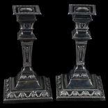 A pair of Victorian Neo-Classical style silver table candlesticks, square tapered form with relief