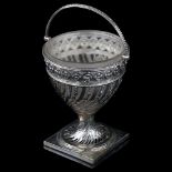 A 19th century swing-handled sugar basket, unmarked silver with pierced floral decoration, height