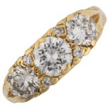 A late 20th century 18ct gold graduated three stone diamond half hoop ring, set with modern round