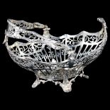A George V silver swing-handled bon bon basket, pierced and raised floral swag decoration, by Josiah