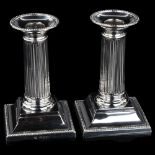 A pair of Edwardian silver column table candlesticks, with beaded edge and removeable sconces, by