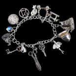 A late 20th century silver curb link charm bracelet, with various silver charms, bracelet length