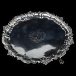 An Irish George III silver salver, circular form with cast foliate rim, raised on 3 feet, by