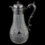 An Edwardian silver-mounted glass Claret jug, relief embossed floral decoration with acanthus leaf