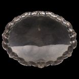 A large George V silver salver, circular form with piecrust edge and cast foliate rim with