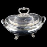 A large silver plated 2-handled soup tureen and cover, with cast foliate decoration on scrolled