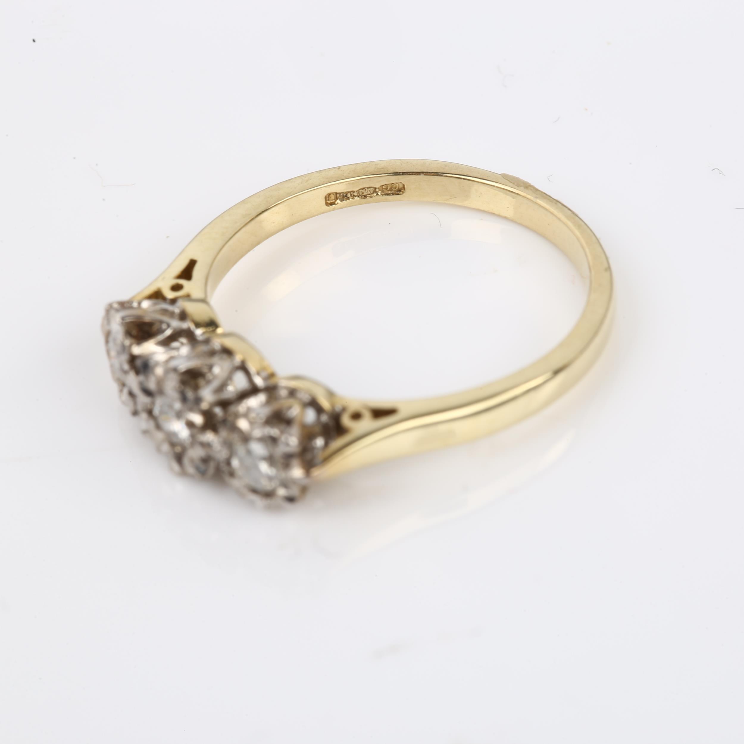 A modern 9ct gold three stone diamond ring, illusion set with modern round brilliant-cut diamonds, - Image 3 of 4
