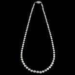 CARTIER - a natural saltwater pearl and diamond necklace, a graduated strand of 82 natural pearls of