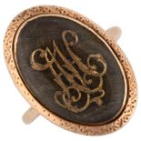 A Georgian memorial ring, unmarked rose gold closed-back settings with plaited hair beneath initials