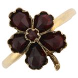 An Antique garnet leaf ring, unmarked yellow metal closed-back settings with faceted garnets,