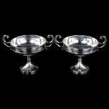 A pair of Edwardian silver pedestal trophy dishes, circular form with scrolled handles, by S W Smith