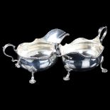 A large pair of Edwardian silver sauce boats, bulbous form with gadrooned rim, shell feet and