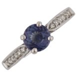 An 18ct white gold tanzanite and diamond dress ring, set with round-cut tanzanite and modern round