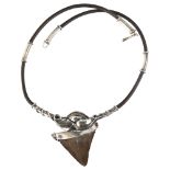 A Scandinavian shark's tooth pendant necklace, unmarked white metal and leather settings, tooth