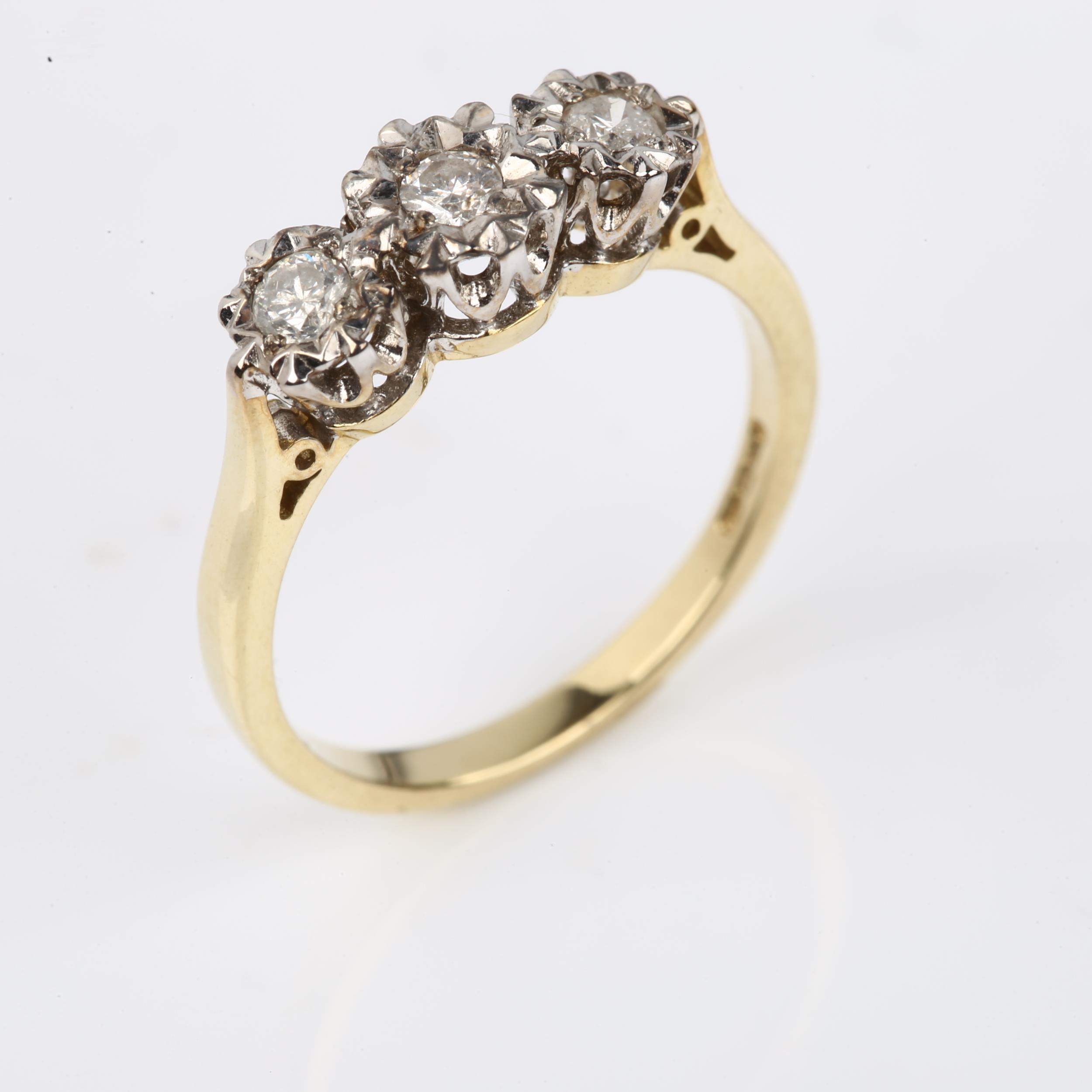 A modern 9ct gold three stone diamond ring, illusion set with modern round brilliant-cut diamonds, - Image 2 of 4