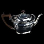 An Edwardian silver teapot, oval form with gadrooned rim and turned wood mounts, by Martin Hall &