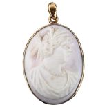 A pink coral cameo pendant, high relief carved depicting female profile, in Chinese 18ct gold frame,
