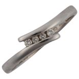 A modern 9ct white gold diamond crossover ring, channel set with modern round brilliant-cut