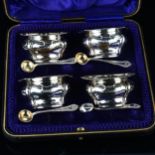 A set of 4 Edwardian silver salt cellars, oval bulbous form with cast shell rim and matching spoons,