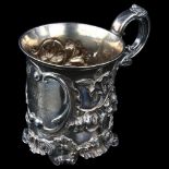 A Victorian silver half pint christening mug, relief embossed floral decoration with foliate handle,