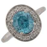An 18ct white gold blue zircon and diamond cluster ring, set with oval mixed-cut zircon and modern